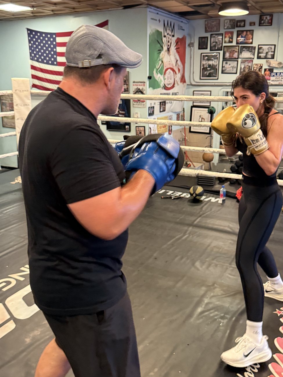 Dino Spencer holding mitts in the ring for a private client mid-session.