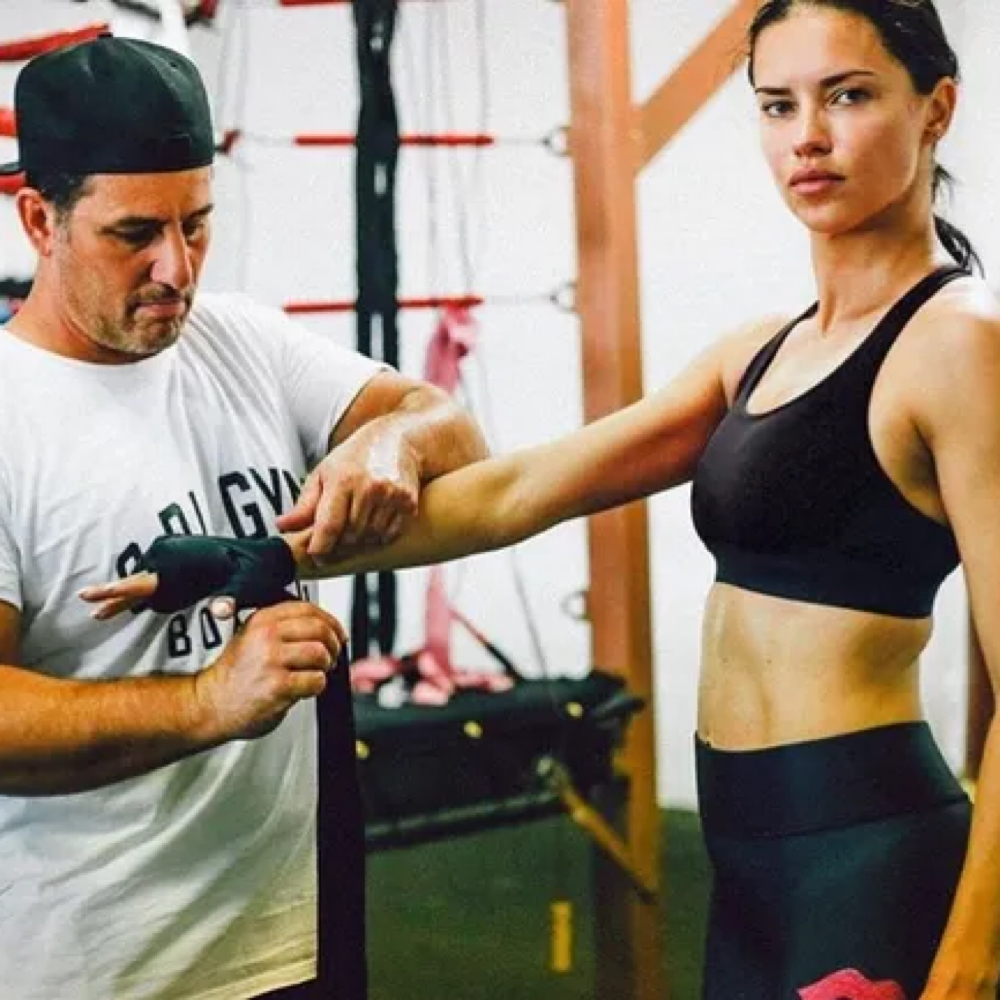 Dino Spencer wrapping Adriana Lima's hands at the 5th Street Gym.