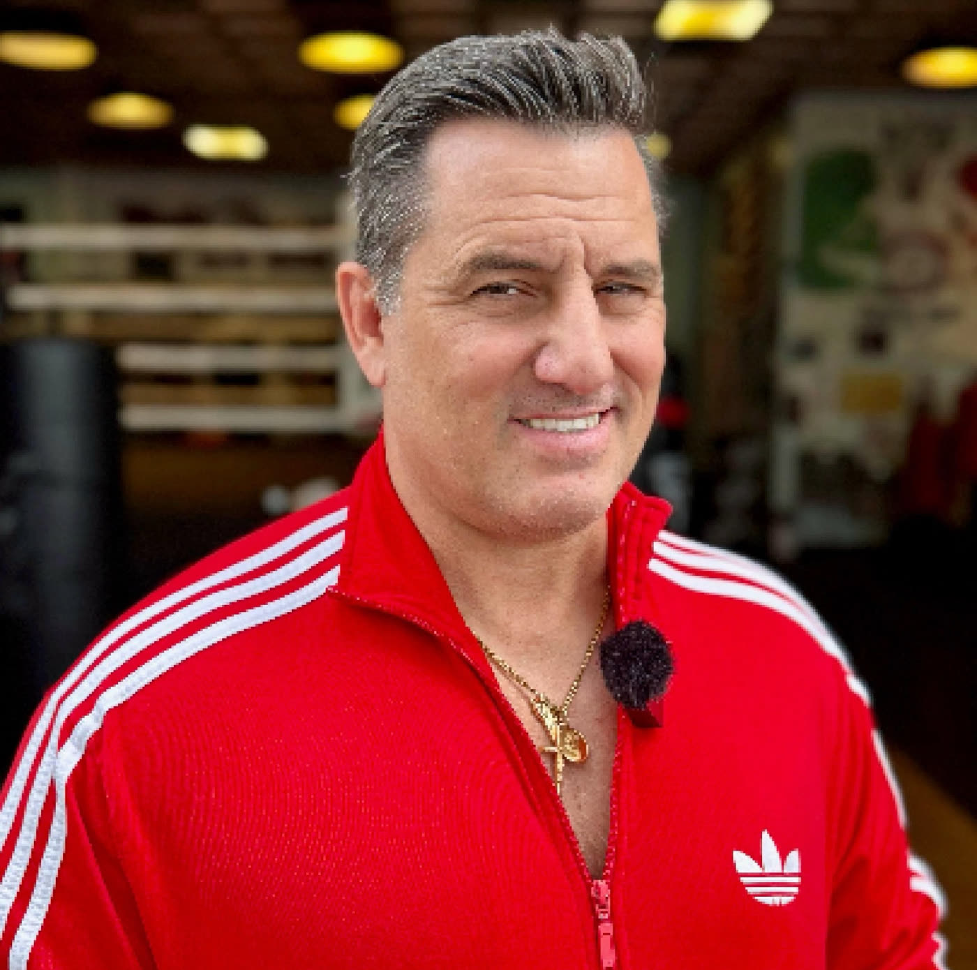 Dino Spencer in the gym, the ring and heavy bags behind him.